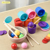Montessori wooden color sorting game featuring rainbow balls and cups in various colors