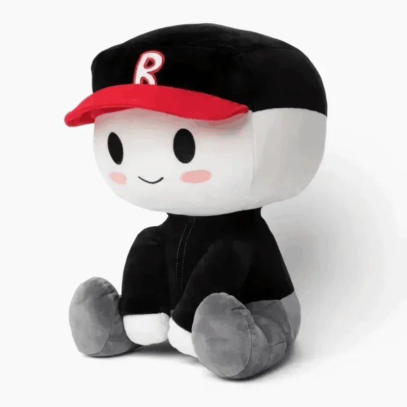 A black plush cartoon character with a red baseball cap featuring the letter R and gray feet.