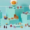 A collection of colorful Mini Brands toys and accessories displayed on a light blue surface.