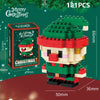 A green and red Santa figure made of interlocking plastic building blocks with a festive Christmas theme.