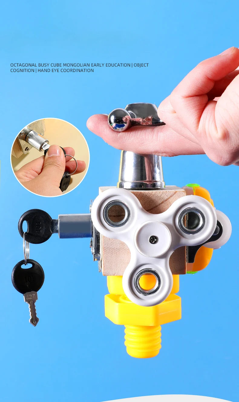 A hand holds a silver key attached to a wooden busy cube toy used for early education and hand eye coordination.