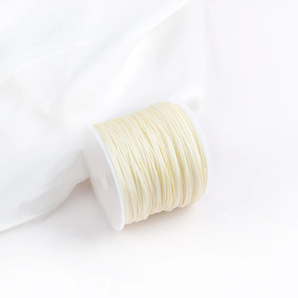 A roll of light yellow cotton nylon macrame cord for jewelry making and crafts.
