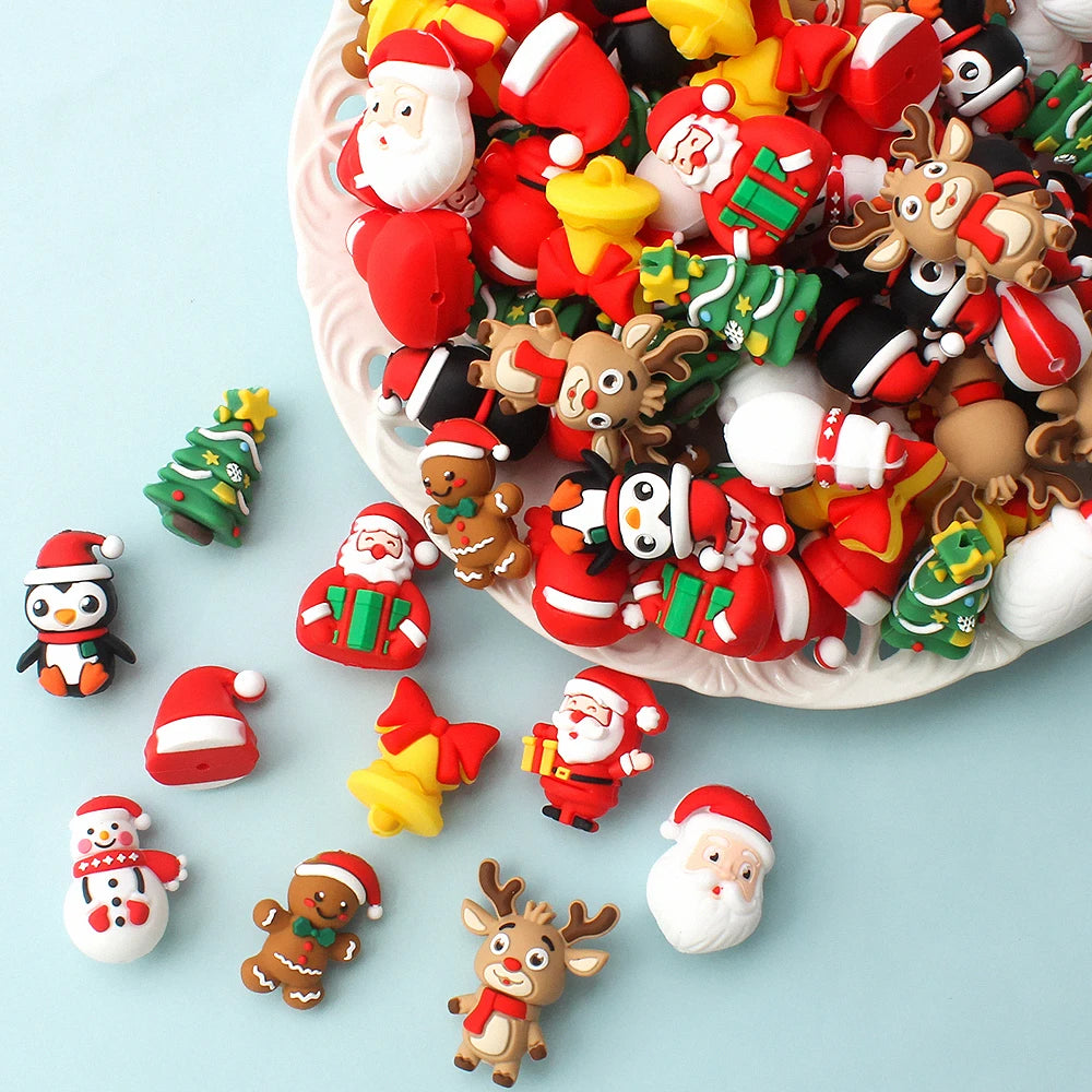 A pile of colorful 3D Christmas Santa and tree silicone beads used for festive craft jewelry charms.