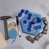 A portable family party game featuring blue and white ice tapping elements, including a wooden hammer, plastic pieces, and a 