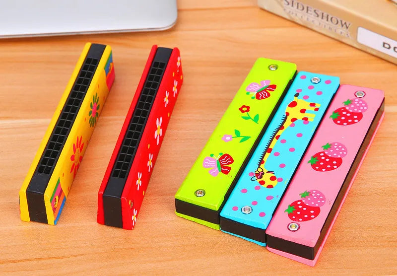 Five colorful wooden harmonica cases featuring cartoon animal designs laid on a wooden surface.