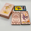 A deck of gold foil tarot cards with a rose pink oracle finish, including a box and individual cards.