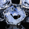 A clear, faceted resin die with a black silhouette of a cat on its surface.