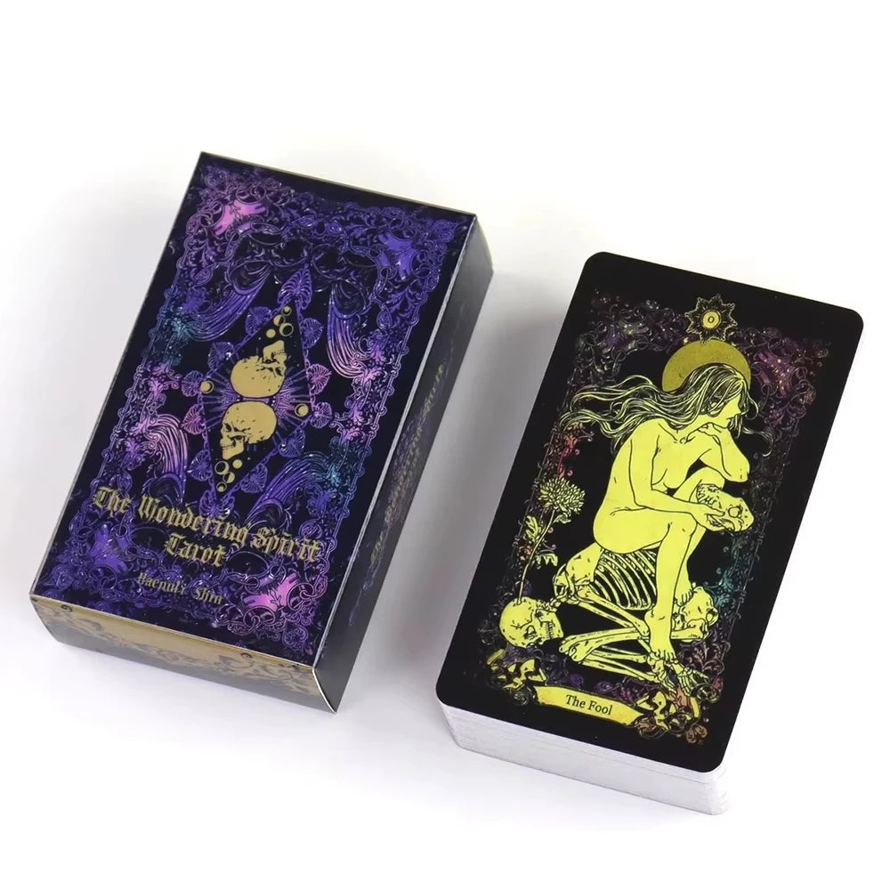 A box of The Wandering Spirit Tarot deck with purple and gold accents.