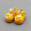 A pair of yellow casual sneakers with white bow details for 17cm Labubu dolls.
