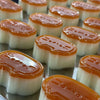 A close-up of orange and white squishy stress-relief toys shaped like cheese or cat, arranged in a row.