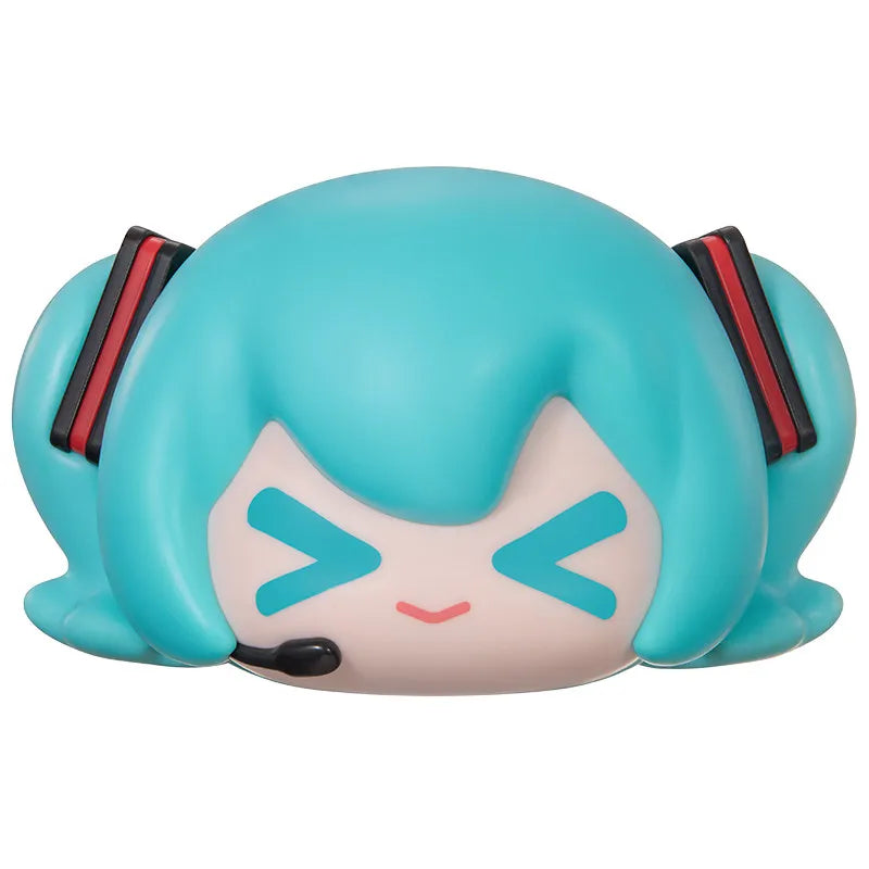 A blind box figure of Hatsune Miku with light blue hair and pink facial markings.