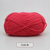 A ball of bright coral red pre-dyed milk cotton yarn for knitting and crochet.