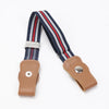 A kids canvas belt with elastic stretch featuring navy blue and red stripes and a tan leather buckle.