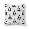A white pillow cover set featuring a repeating pattern of black ghost faces for Halloween decoration.