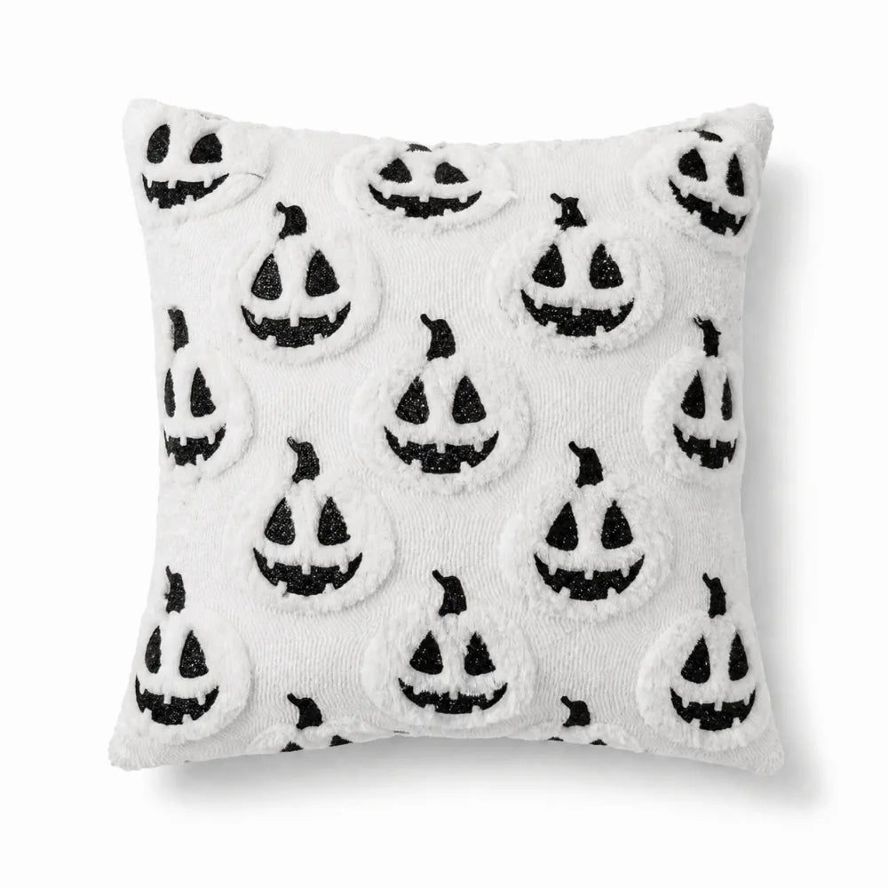 A white pillow cover set featuring a repeating pattern of black ghost faces for Halloween decoration.