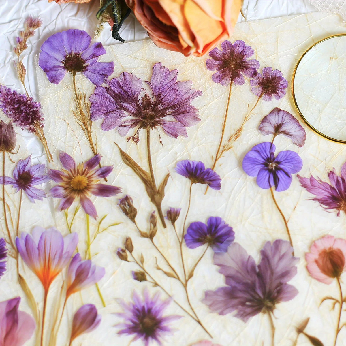 A collection of purple and pink floral PET stickers on a light background for journals and crafts.