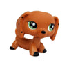 An orange dachshund pet figurine with large green eyes.
