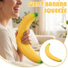 A person is squeezing a yellow banana, demonstrating the giant banana squeeze stress relief toy.