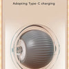 A close-up view of a silicone pet toy ball designed for cats, showing the material and charging port.