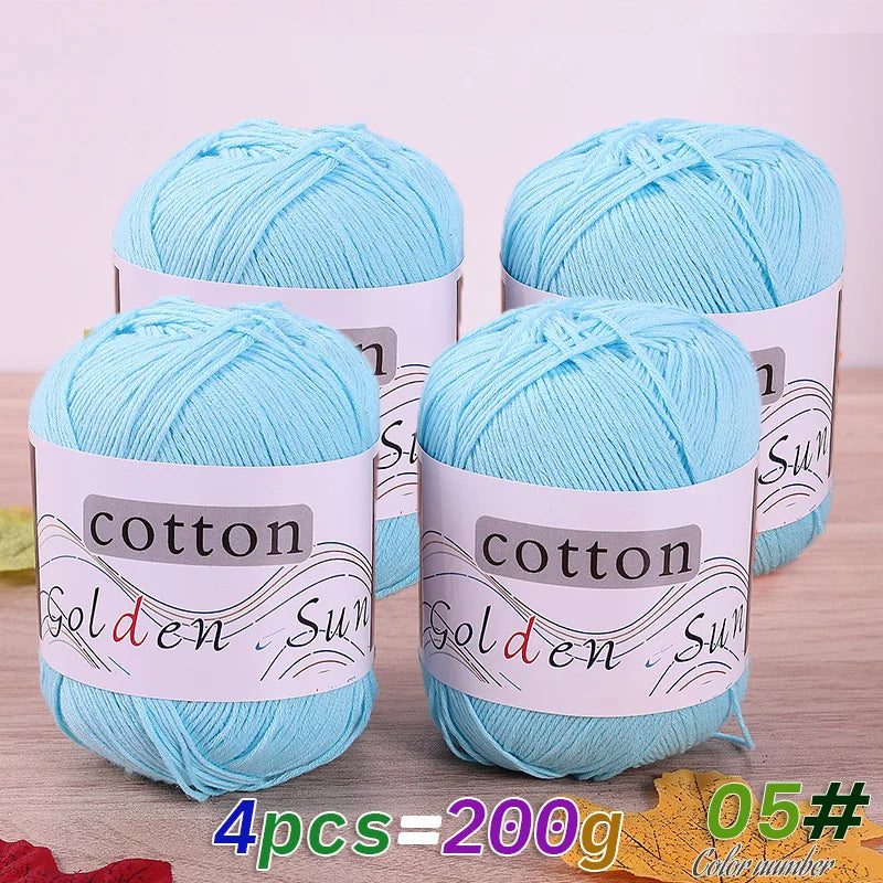 Four skeins of light blue cotton knitting yarn for crochet and handmade projects
