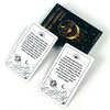 A set of Messages From The Universe Oracle cards and a black deck box with an astrological design.