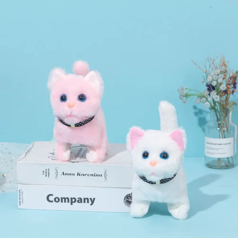 A pink and white plush cat toy with black accents is displayed on a box against a light blue background.