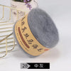 A ball of gray silk mohair blended yarn is shown next to a gold wire rack.