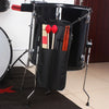 A black drumstick carrier bag with a handle and wooden drumsticks is displayed on a stand.