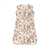 A sleeveless cotton baby sleeping bag sack with a floral print featuring pink and green roses on a cream background.