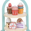 A wooden pretend play tea party set featuring pink and yellow food items displayed on a light blue arch stand.