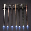 A set of five LED light-up magic wands displayed in a black box on a dark surface.