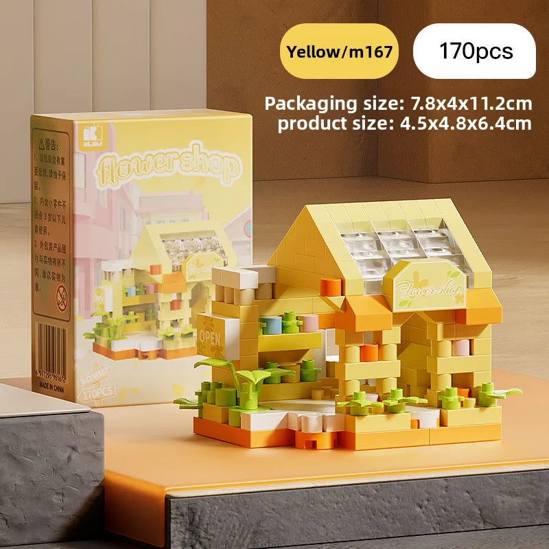 A yellow micro building block set depicting a house scene with plants and figures, packaged for Christmas decor.