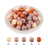 A collection of 15 hexagonal silicone beads in various shades of peach, pink, and orange.