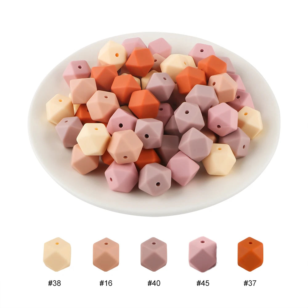 A collection of 15 hexagonal silicone beads in various shades of peach, pink, and orange.