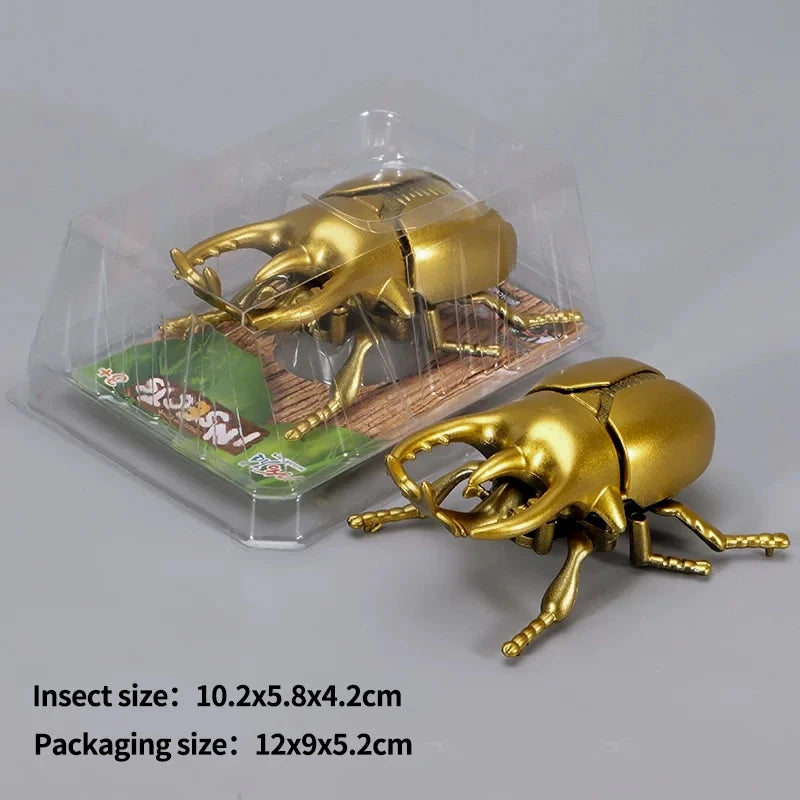 A set of three gold-colored wind-up insect toys, including a ladybug, bee, and beetle, packaged in clear plastic.
