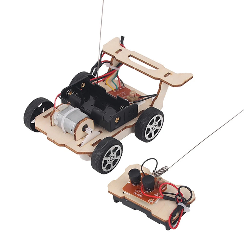 A wooden paddle boat kit with a motor and propeller is shown on a light brown wooden base.