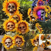 A display of skull-themed sunflowers used as garden decorations on stakes.