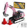 A pink mini RC excavator toy with a yellow control panel and a shovel, surrounded by safety cones and instructions.