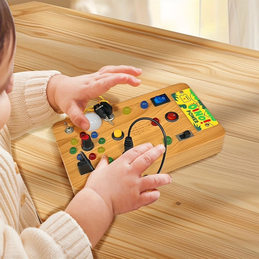 A child is interacting with a wooden LED light-up busy board featuring various colorful buttons and components.