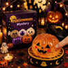 An orange carved pumpkin Halloween themed squishy stress relief toy sits in a wooden tray surrounded by spooky decorations.