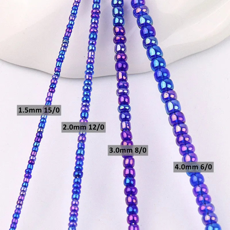 A close-up photo showing various sizes of purple and blue glass rice beads for jewelry making