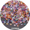 A close-up view of a mix of colorful round loose glass seed beads for jewelry making.