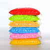 A stack of colorful fuse beads in various shades including red, green, orange, blue, pink, and yellow.
