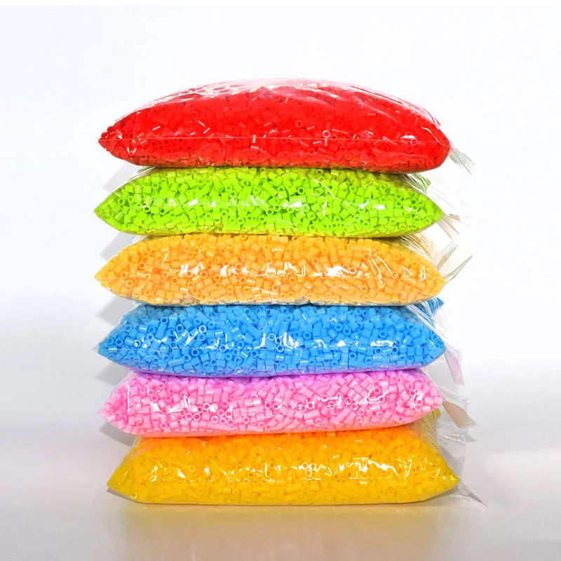 A stack of colorful fuse beads in various shades including red, green, orange, blue, pink, and yellow.