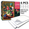 Box of a 1000-piece painting puzzle featuring fruit and flowers with included adhesive paper sheets