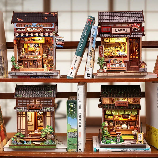 A collection of detailed wooden book nook building kits featuring traditional Japanese architecture and miniature scenes.