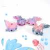 A set of eight colorful flexible salamander figurines in shades of pink, purple, and blue.
