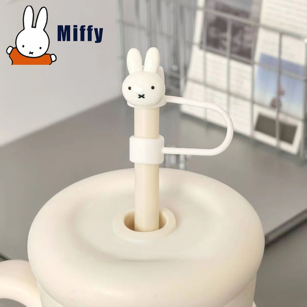 A white Miffy straw topper with a rabbit design is shown on a light gray surface.