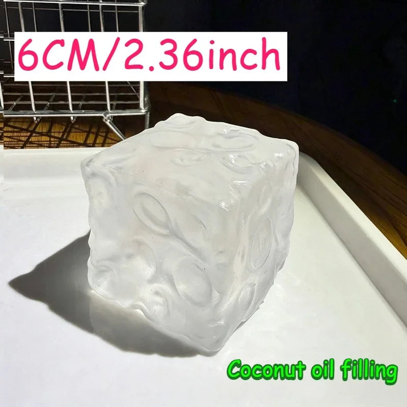 A clear, squishy block of coconut oil filling is shown on a white surface.