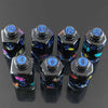 A set of seven floral resin potion bottle polyhedral dice, numbered 4 through 10 and 12, displayed on a dark surface.